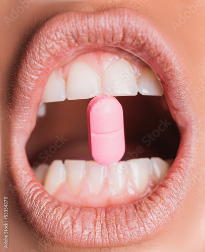 close up of lips with teeth. Pills. Woman sexy lips. Sensual. Sensuality. Beauty. 