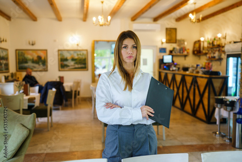 One woman young adult female caucasian standing at the restaurant preparing for meeting and waiting for her clients Entrepreneur manager business modern lifestyle concept