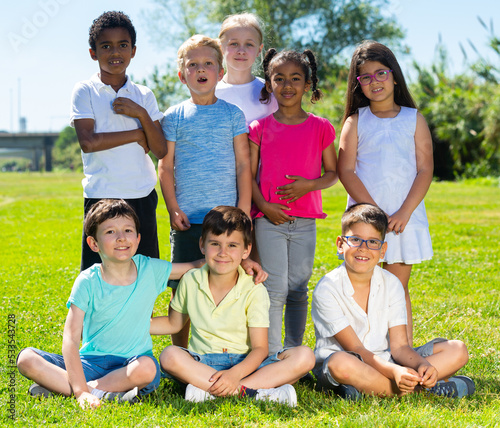 Portrait of eight children who are walking and posing in the park