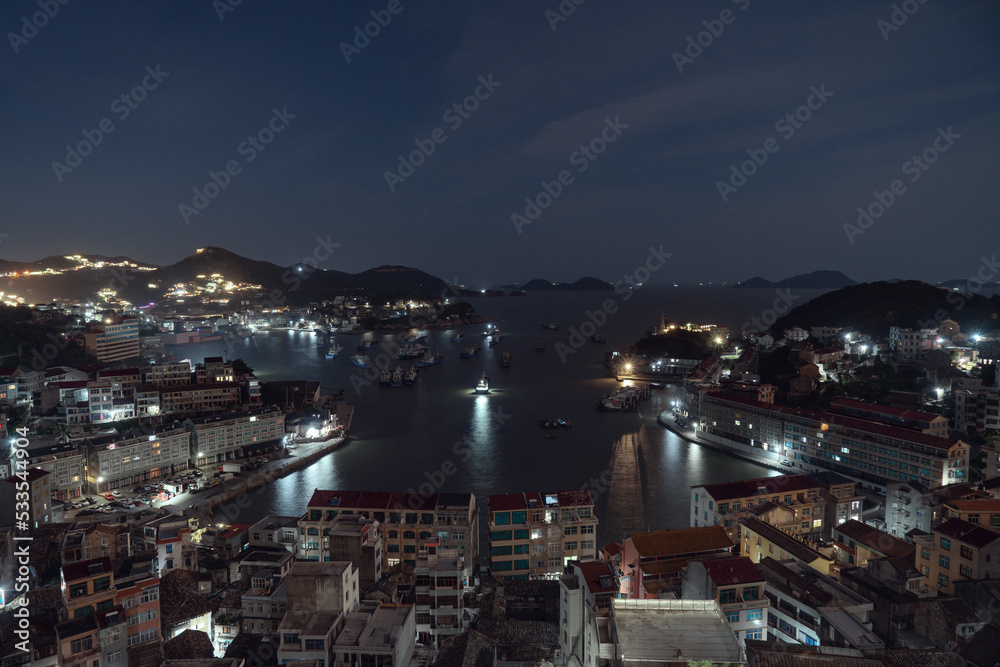 Seaside port with residental houses around at night, in Taizhou, Zhejiang.