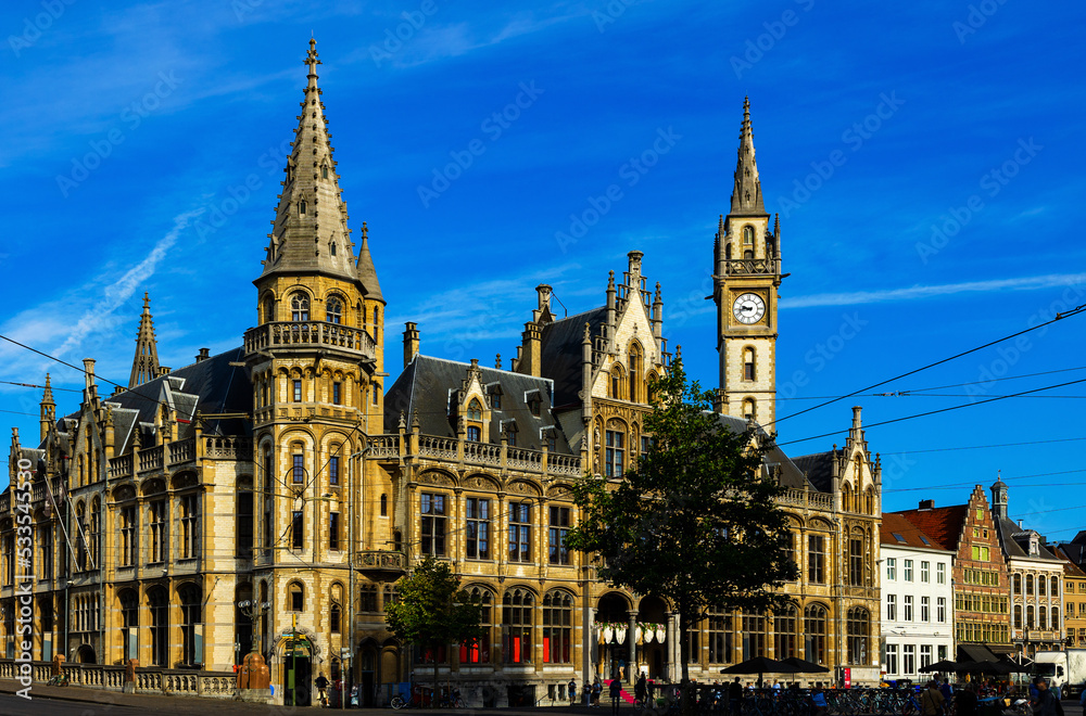Ghent, Old Post Office on Korenmarkt Square under deep blue sky. Flemish Region of Belgium.