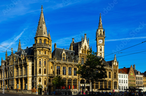 Ghent  Old Post Office on Korenmarkt Square under deep blue sky. Flemish Region of Belgium.