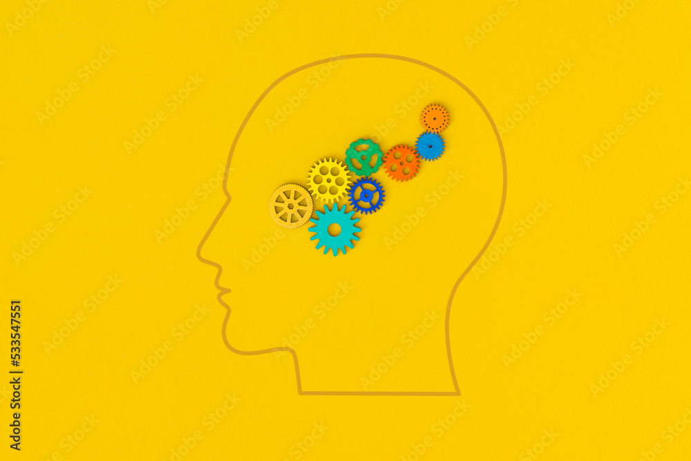 Human head with gears on yellow background