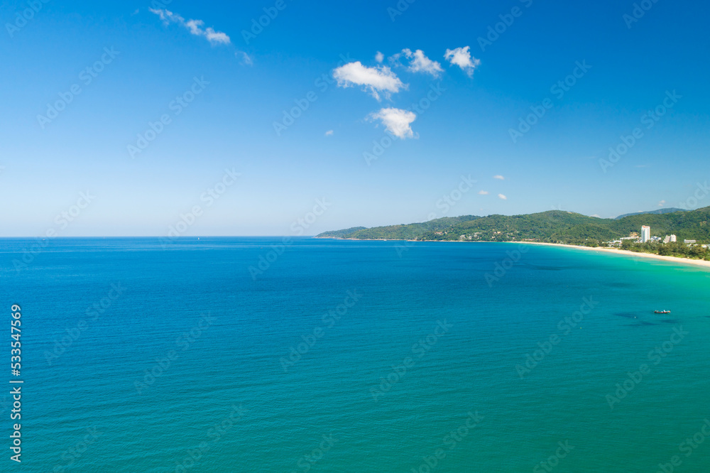 Aerial view of a blue sea surface water texture background,Amazing sea sun reflections, Aerial flying drone view Waves water surface texture on sunny tropical ocean in Phuket island Thailand