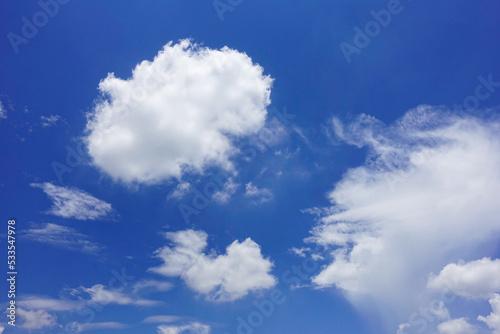 Puffy fluffy white clouds blue sky.