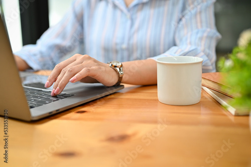 cropped image, Professional Asian businesswoman typing on laptop keyboard