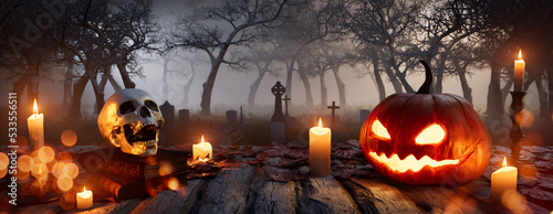 Seasonal Background with Jack-O-Lantern, Skull and Candles in a Eerie Churchyard. Halloween concept.