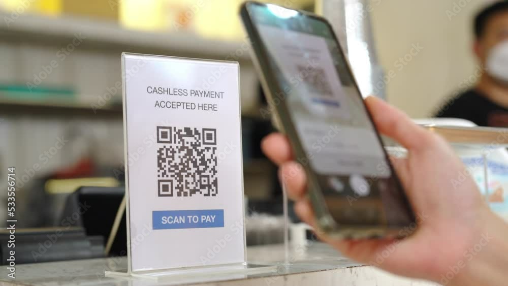 Asian woman enjoy shopping at street market on summer holiday vacation. Attractive girl using mobile phone scan QR code on bar counter making online payment buying iced coffee at outdoor coffee shop.