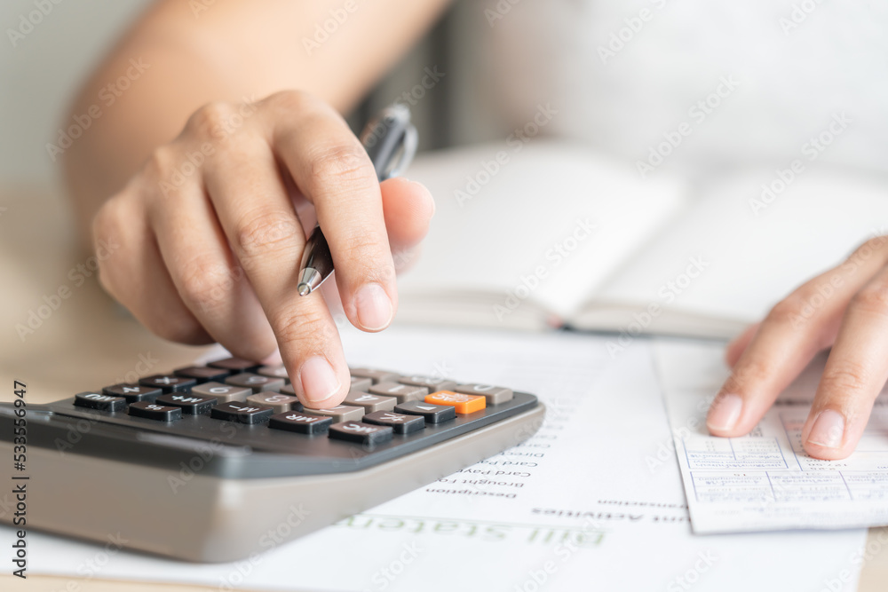 Woman calculate bill budget payment, home accounting concept with calculator Woman calculate bill budget payment, home accounting concept with calculator