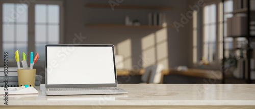 Workspace close-up with laptop mockup, stationery and copy space on white tabletop