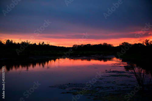 colorful sunset over the pond © Holly