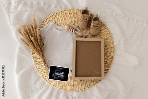 Mockup of baby bodysuit shirt . Baby Announcement. Pregnancy announcement background with blurred . Selective focus photo