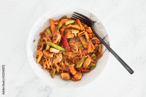 healthy plant-based food, vegan stir-fry vegetables with vermicelli noodles and satay sauce
