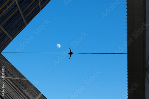 Man balancing on the rope risk taking concept photo