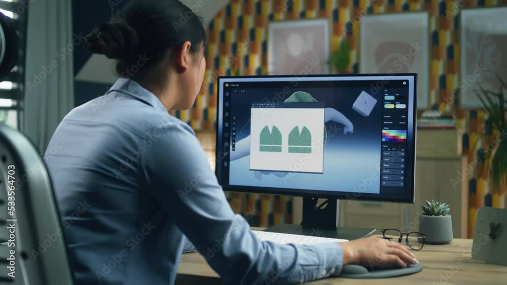 Female designer creating 3D visualization of clothes using computer and professional software while working remotely from home