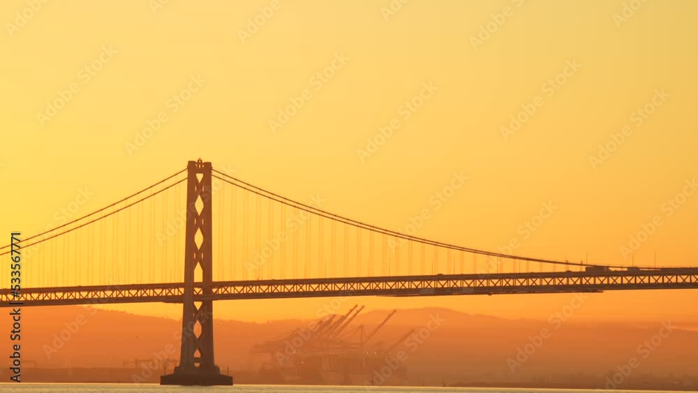 San Francisco Oakland Bay Bridge landmark, 4k video during a beautiful sunrise with spectacular sky. Travel to California, United States. San Francisco Oakland Bay Bridge landmark, 4k video during a beautiful sunrise with spectacular sky. Travel to California, United States.