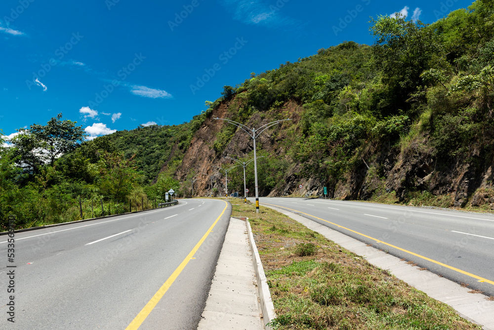 Double carriageway west of the department of Antioquia, Colombia. Landscapes with dual carriageway, mountains and blue sky