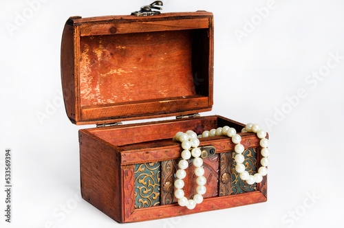 open treasure chest with pearl necklace inside it
