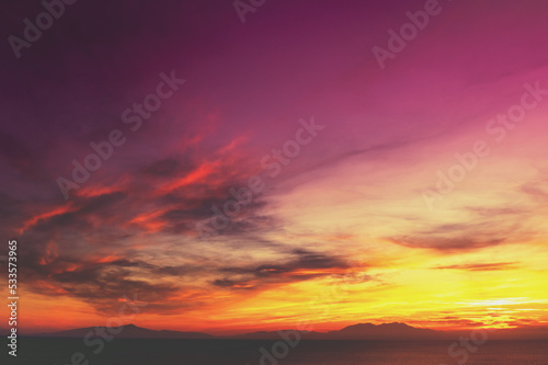 Colorful cloudy sky at sunset. The sun sets behind Mount Olympus, Greece