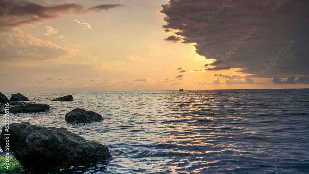 Bright sunset with large yellow sun under the sea surface. Bright sunset with large yellow sun under the sea surface.