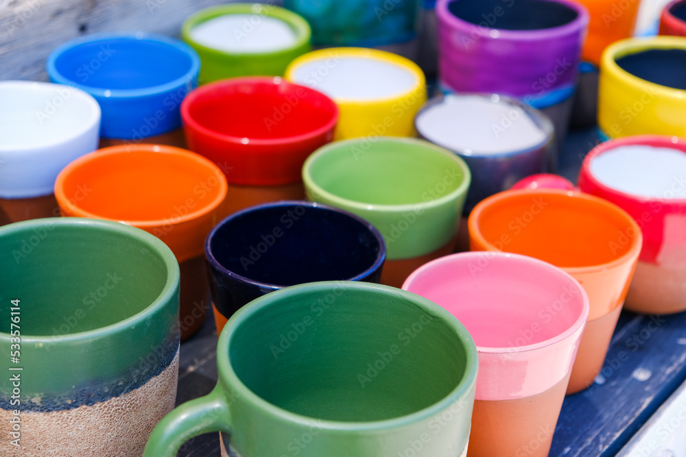 Set of colorful cups closeup in street retail store Set of colorful cups closeup in street retail store