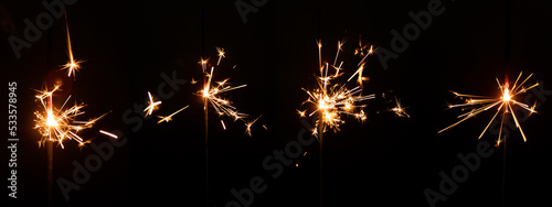 Set of sparkler with sparks with lens glare on black background for overlay blending mode for holiday design projects. photo