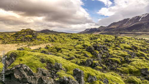 Lava fields stretching along the mountains in the north of Iceland photo