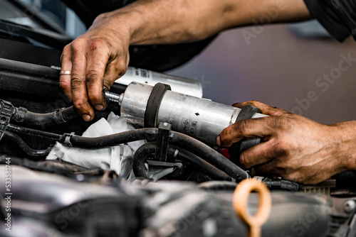 Close up of auto mechanic repairing car engine in car service © fotofabrika