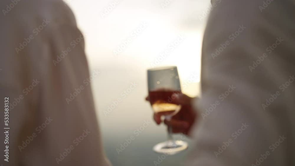 Caucasian couple celebrating at luxury skyscraper rooftop bar at summer sunset. Confident man and woman couple enjoy city lifestyle having dinner and cocktail drink at outdoor restaurant in evening. Caucasian couple celebrating at luxury skyscraper rooftop bar at summer sunset. Confident man and woman couple enjoy city lifestyle having dinner and cocktail drink at outdoor restaurant in evening.