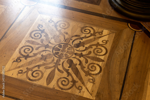 Vintage wooden parquet with floral inlay  pattern photo