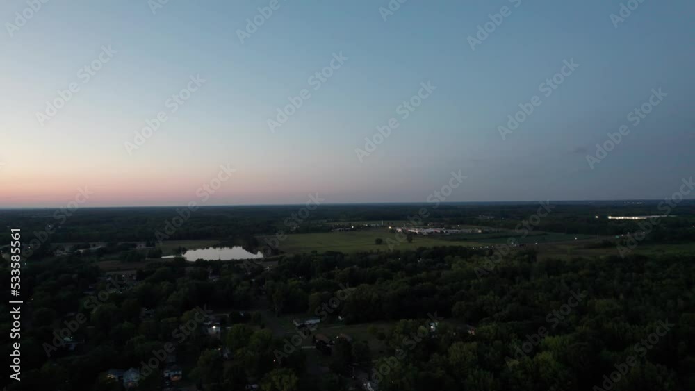 A drone shot of a beautiful vast land along with a small canal in the evening time with clean blue sky background A drone shot of a beautiful vast land along with a small canal in the evening time with clean blue sky background