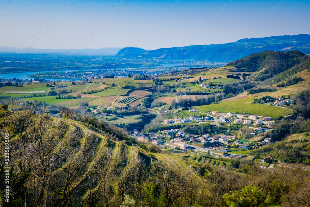 Obraz premium View on Crozes-Hemritage small village, the Rhone Valley vineyards and the Ardeche mountains from the Mejeans belvedere (Drome, France)