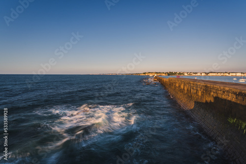 Slika na platnu Lighthouse and embankment by the sea