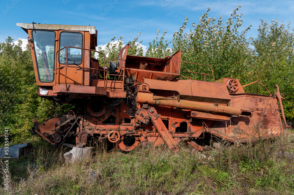 Old rusty agricultural machinery. Abandoned harvester, tractor Old rusty agricultural machinery. Abandoned harvester, tractor