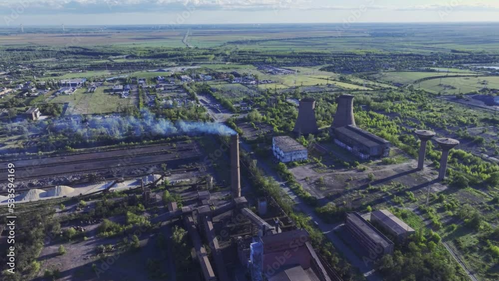 Metal recycling plant, drone push-in tilt-down shot. Metal recycling plant, drone push-in tilt-down shot.