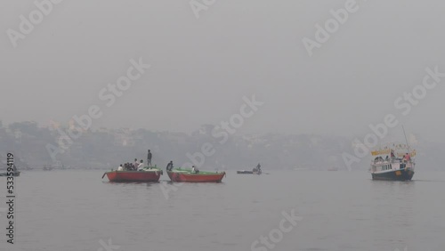 Pilgrims  And Boats With Flags at Kumbh mela photo