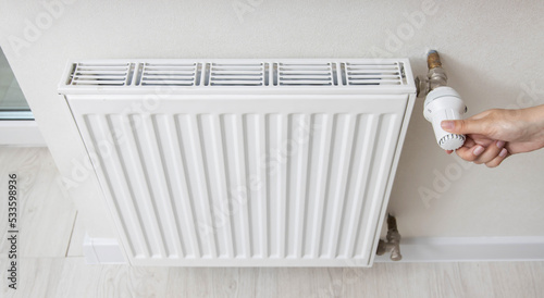 Wallpaper Mural A woman regulates the gas heating in the room in order to save gas energy, taking into account the sanctions. Comfortable heating in the house. Copy space for text Torontodigital.ca