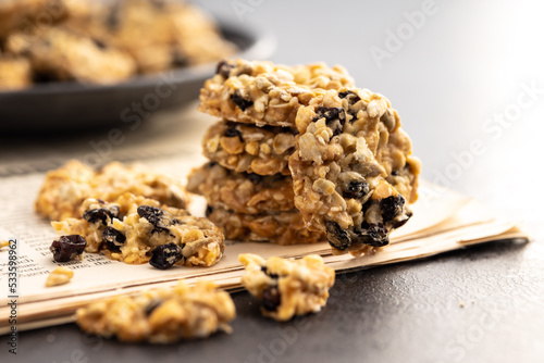 Wholegrain oat cookies. Cookies with oatmeal and raisins on newspapers.