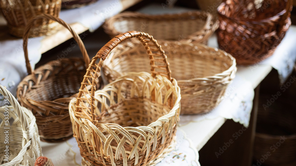 Beautiful wicker baskets on the table. Brown textured picnic and food carrying baskets, background