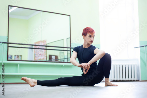 Female dancer stretching before choreography practice. Physical exercises are important for avoiding muscle strains