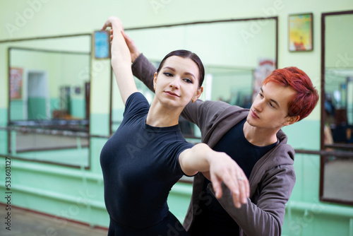 Male dance tutor helps ballerina to learn new moves and perform them correctly. Dance teacher, learning choreography
