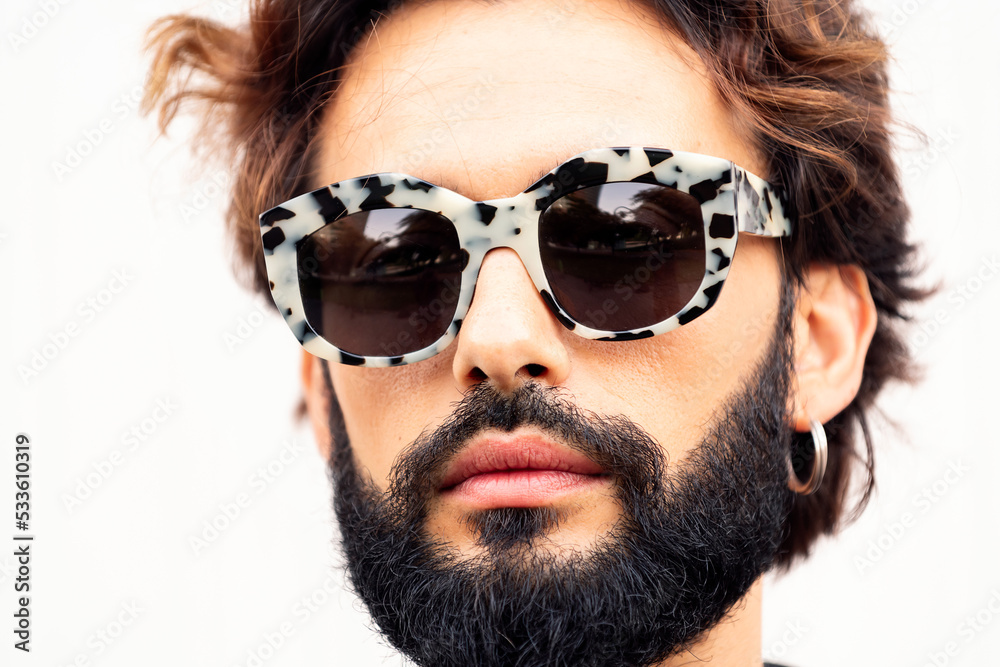close up portrait of a beautiful young man with beard and fashionable sunglasses in a white background, concept of urban lifestyle and stylish clothing close up portrait of a beautiful young man with beard and fashionable sunglasses in a white background, concept of urban lifestyle and stylish clothing