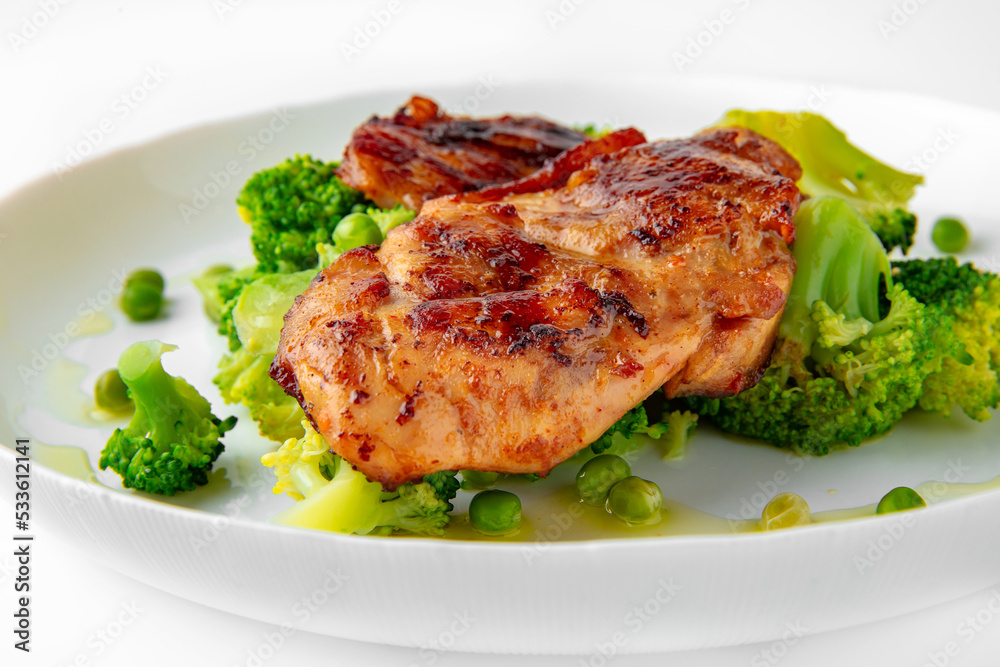Steak with chicken or turkey with vegetables. Balanced, nutritious, tasty and nutritious food. Ready-made menu for a restaurant or for delivery. Dish in a white plate isolated on a white background. Steak with chicken or turkey with vegetables. Balanced, nutritious, tasty and nutritious food. Ready-made menu for a restaurant or for delivery. Dish in a white plate isolated on a white background.