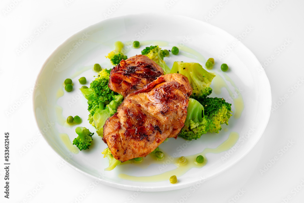 Steak with chicken or turkey with vegetables. Balanced, nutritious, tasty and nutritious food. Ready-made menu for a restaurant or for delivery. Dish in a white plate isolated on a white background. Steak with chicken or turkey with vegetables. Balanced, nutritious, tasty and nutritious food. Ready-made menu for a restaurant or for delivery. Dish in a white plate isolated on a white background.