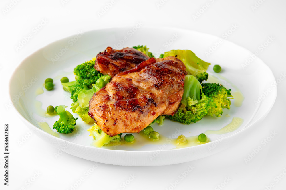 Steak with chicken or turkey with vegetables. Balanced, nutritious, tasty and nutritious food. Ready-made menu for a restaurant or for delivery. Dish in a white plate isolated on a white background. Steak with chicken or turkey with vegetables. Balanced, nutritious, tasty and nutritious food. Ready-made menu for a restaurant or for delivery. Dish in a white plate isolated on a white background.