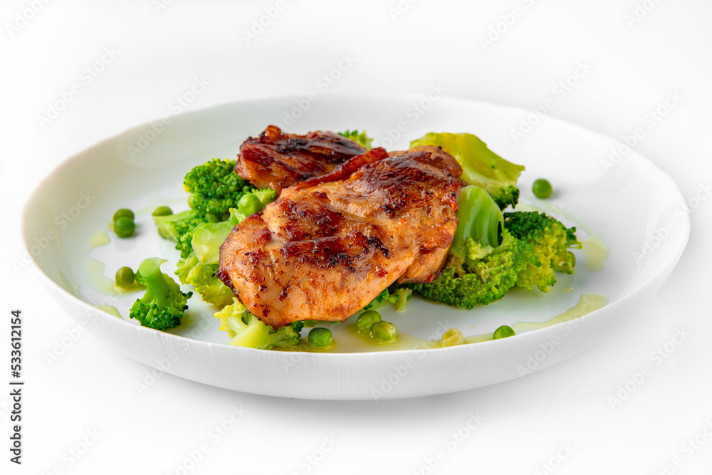 Steak with chicken or turkey with vegetables. Balanced, nutritious, tasty and nutritious food. Ready-made menu for a restaurant or for delivery. Dish in a white plate isolated on a white background. Steak with chicken or turkey with vegetables. Balanced, nutritious, tasty and nutritious food. Ready-made menu for a restaurant or for delivery. Dish in a white plate isolated on a white background.