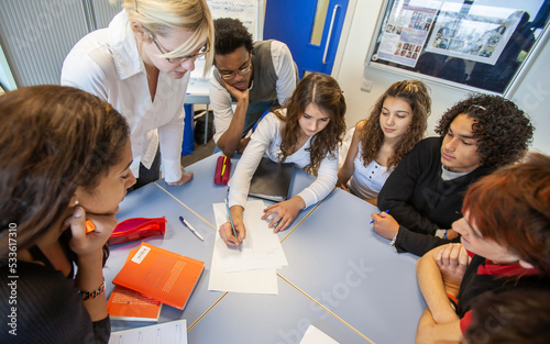 Teenage Students: Groupwork. A group of students working together with their teacher. From a series of related images. photo
