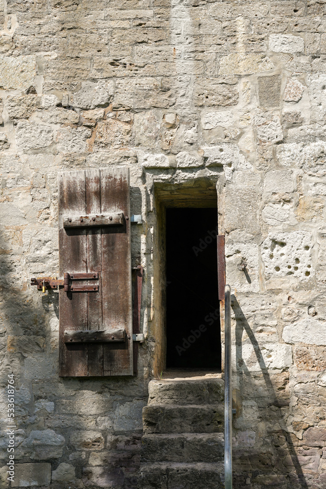 Old wooden door in the old wall.