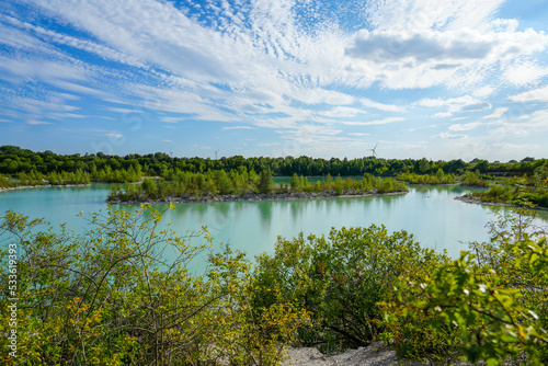 Fototapeta Naklejka Na Ścianę i Meble -  View of the Dyckerhoff lake in Beckum. Quarry west. Blue Lagoon. Landscape with a turquoise blue lake and the surrounding nature.
