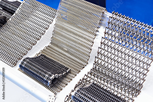 Fotografie Metal wire mesh conveyor belts on stand